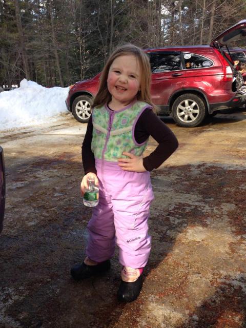 Girl in snow-pants smiling