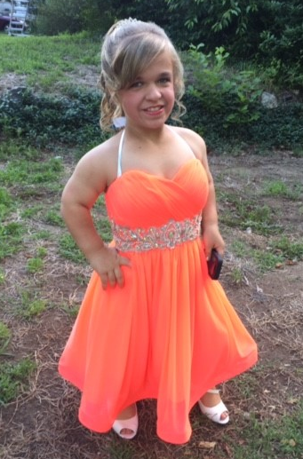 Lacie Mae in an orange dress
