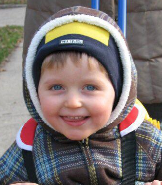 Young boy in a plaid coat.