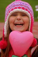 Shawna in a pink hat smiling with a pink heart