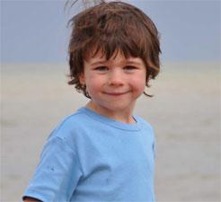 Young boy with brown hair and blue t-shirt