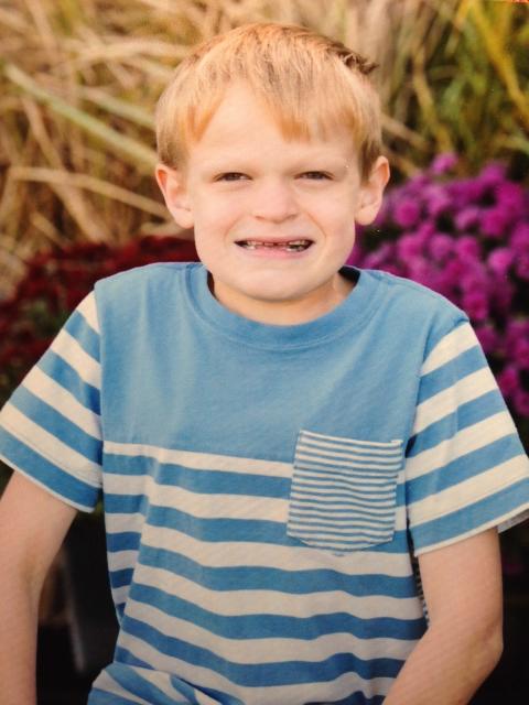 Travis in a blue and white striped shirt